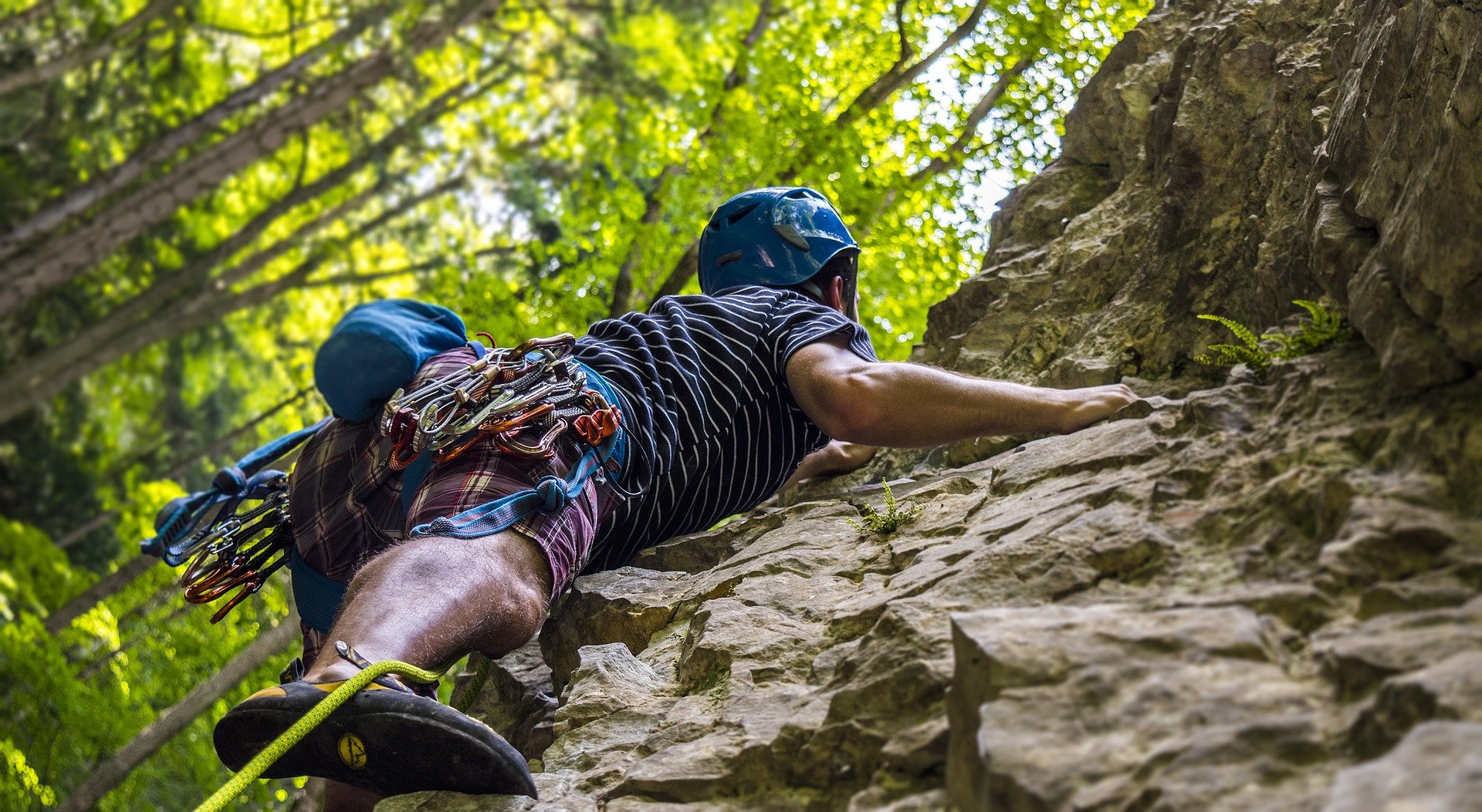 man scaling rock face