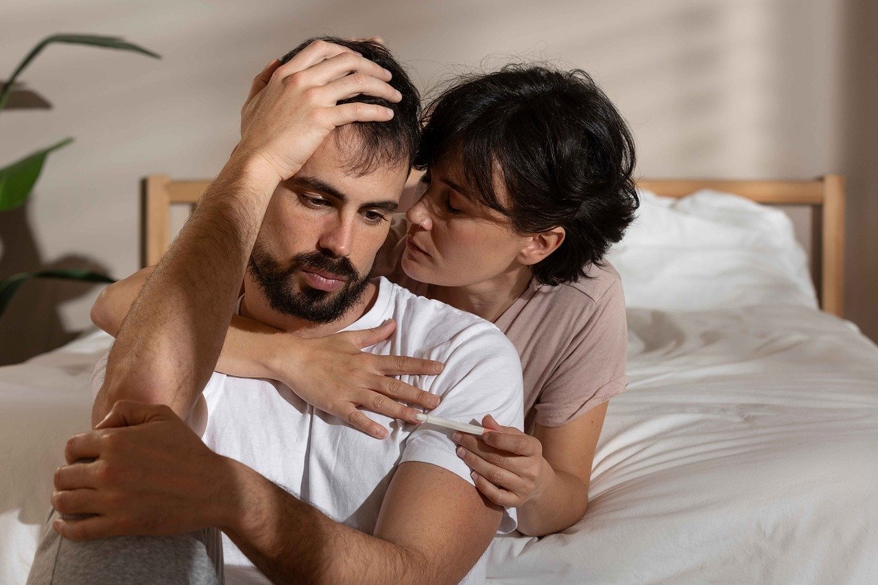 woman comforting sad-looking man