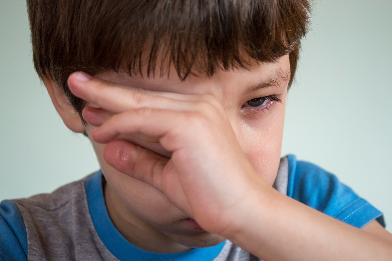 boy hiding his tears